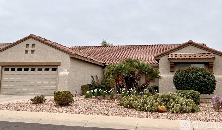 A house with a red tile roof and a garage door.