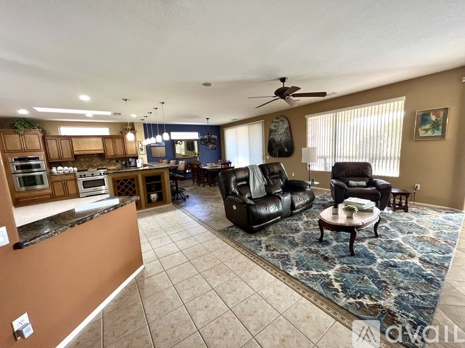 A living room with a black leather chair and a brown counter.