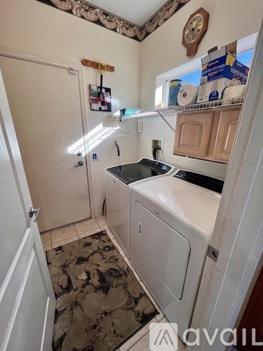 A small kitchen with a white fridge and a black stove top.