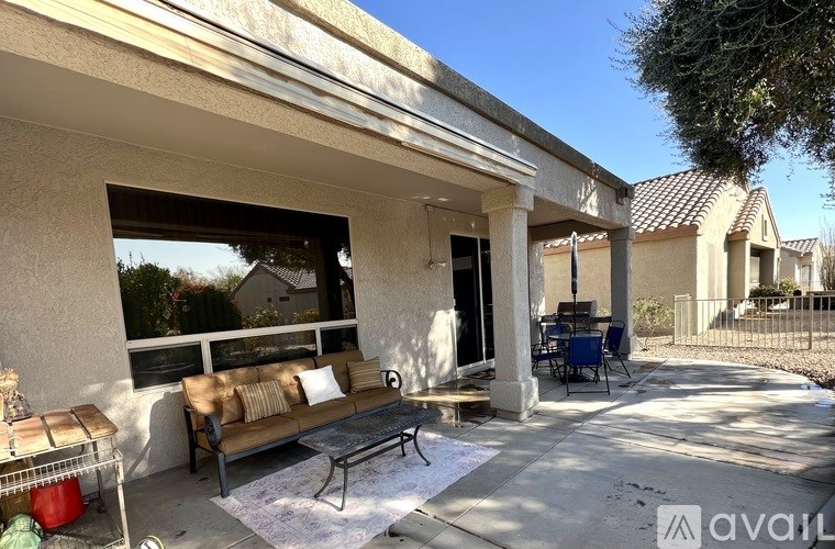 A patio with a couch and chairs is shown in the image.