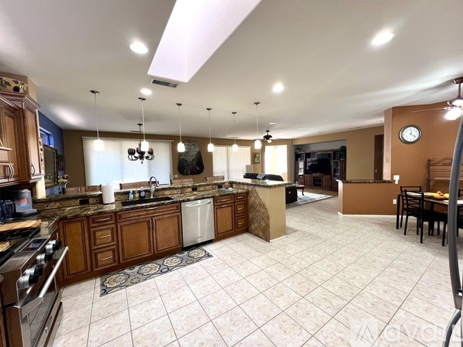 A kitchen with a tile floor and a large island in the middle.