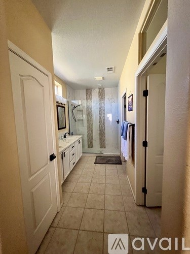 A hallway with a door on the left and a door on the right.