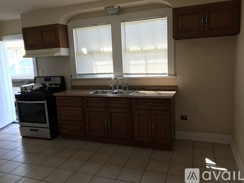 A kitchen with brown cabinets and a white stove top oven.