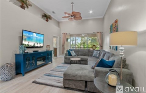 A living room with a grey couch and a blue cabinet.