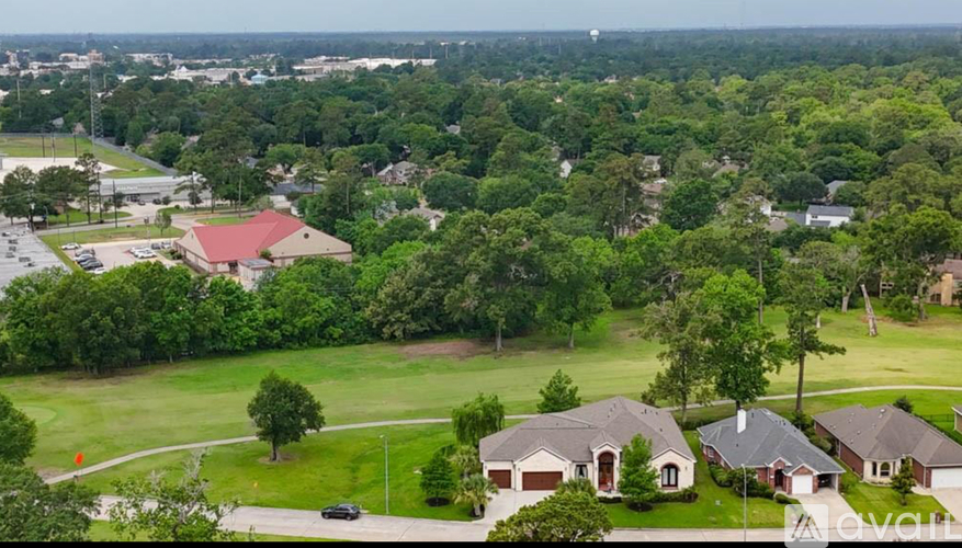 A bird's eye view of a suburban neighborhood with houses and trees.