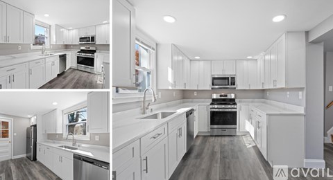 A modern kitchen with white cabinets and appliances.
