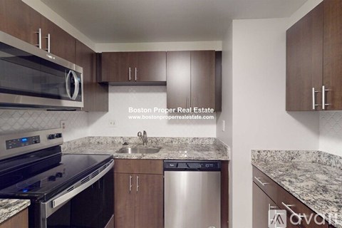 A kitchen with a stove top oven, microwave, and a sink.