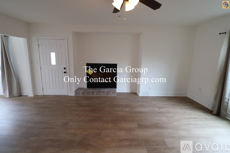 A room with a ceiling fan and a large door.