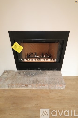 A fireplace with a note attached to it that says "The Garcia Group - Only Contact Arciagp.com".