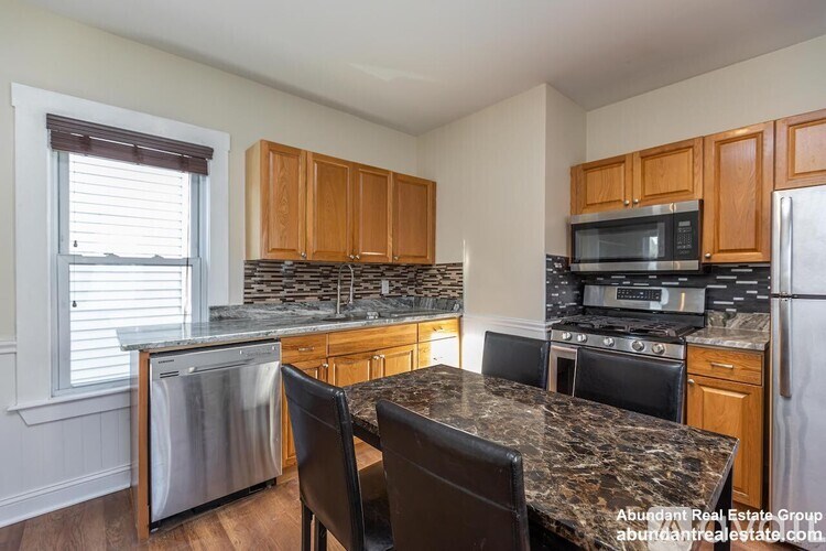 A kitchen with granite countertops and stainless steel appliances.