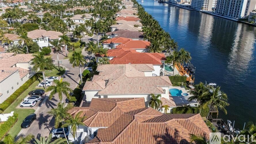 A row of houses with a body of water in front of them.