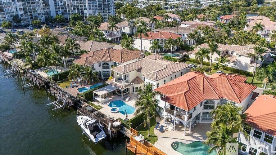 A marina with boats and houses.