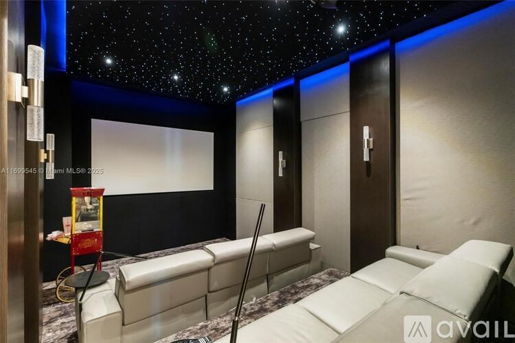 A room with a starry sky on the ceiling and a bed in the foreground.