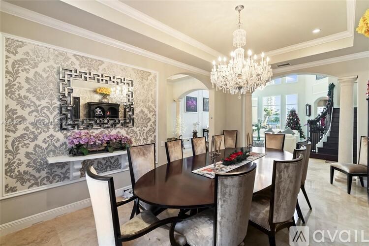 A dining room with a large table and chairs.