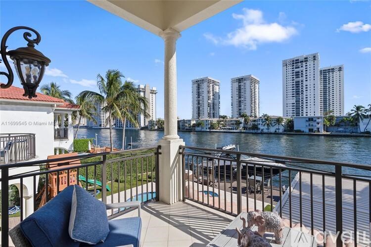 A balcony with a view of a river and buildings.