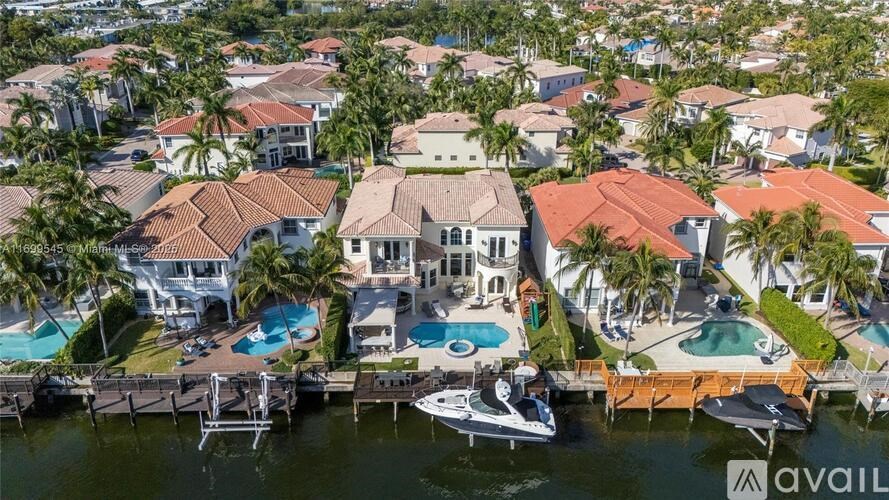 A row of houses with a boat docked in front.