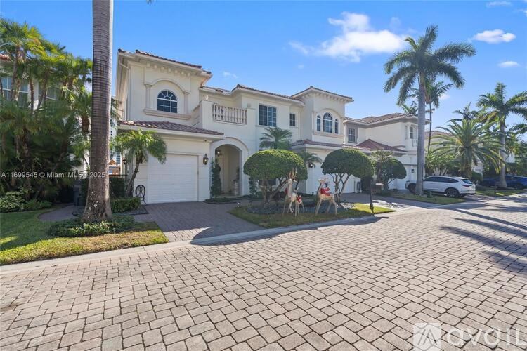 A large, two-story house with a driveway in front.