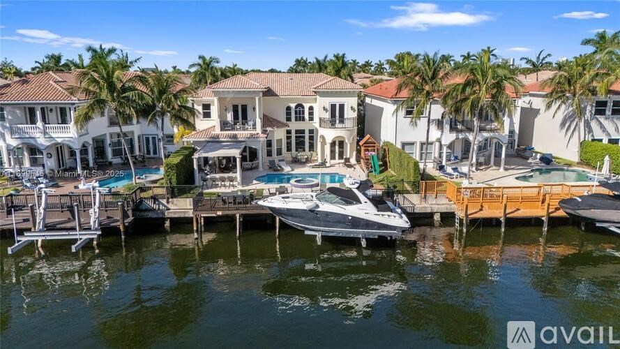 A row of houses with boats docked in front.