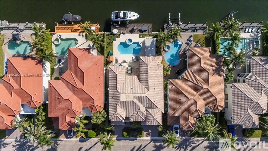 A row of houses with a boat in the water.