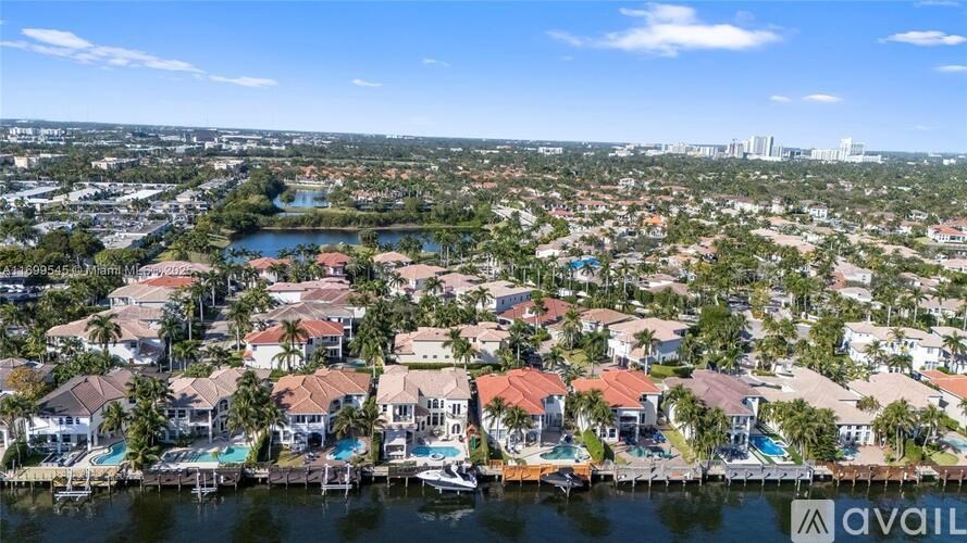 A bird's eye view of a residential area with houses and boats.