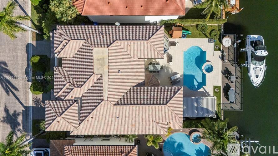 A house with a swimming pool and a boat in the yard.