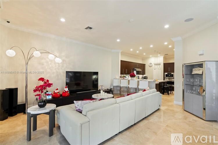 A modern living room with a white sofa and a television.