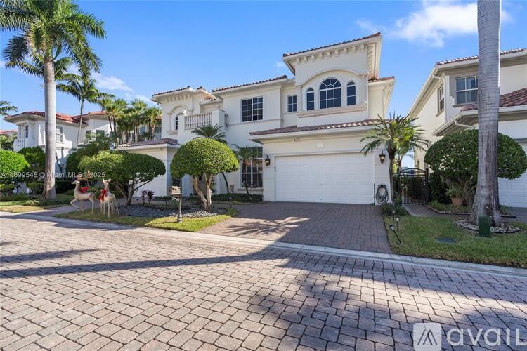 A large, well-maintained house with a driveway in front.