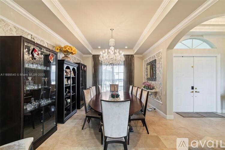 A dining room with a table set for six and a chandelier hanging from the ceiling.