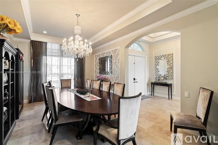 A dining room with a wooden table and chairs.