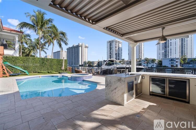 A patio with a pool and a view of the city.