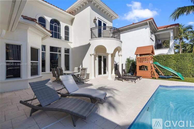 A large white house with a pool in the backyard.