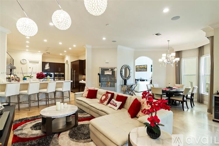 A modern living room with a white sofa and a coffee table.
