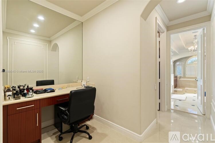 A well-lit home office with a desk and chair.
