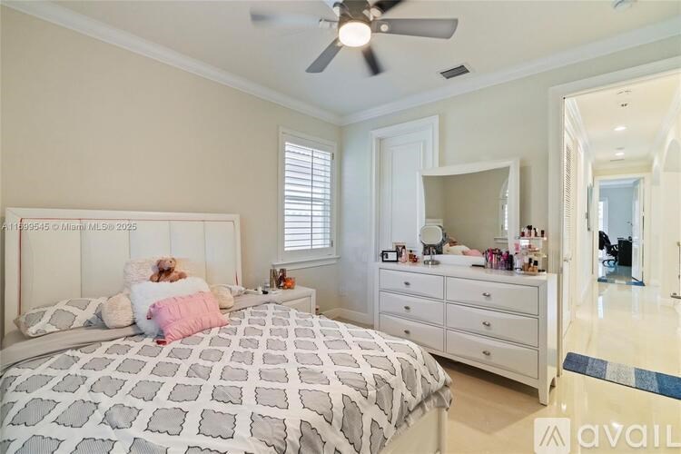 A bedroom with a bed, dresser, mirror, and a teddy bear.