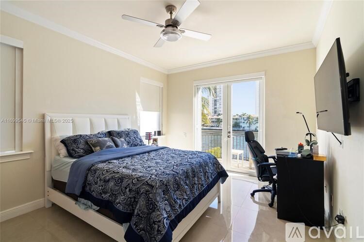 A bedroom with a bed, desk, and chair.