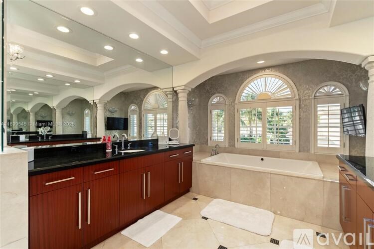 A spacious bathroom with a large tub and double sinks.