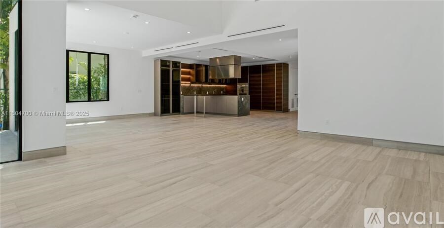 A spacious room with wooden flooring and a modern design.