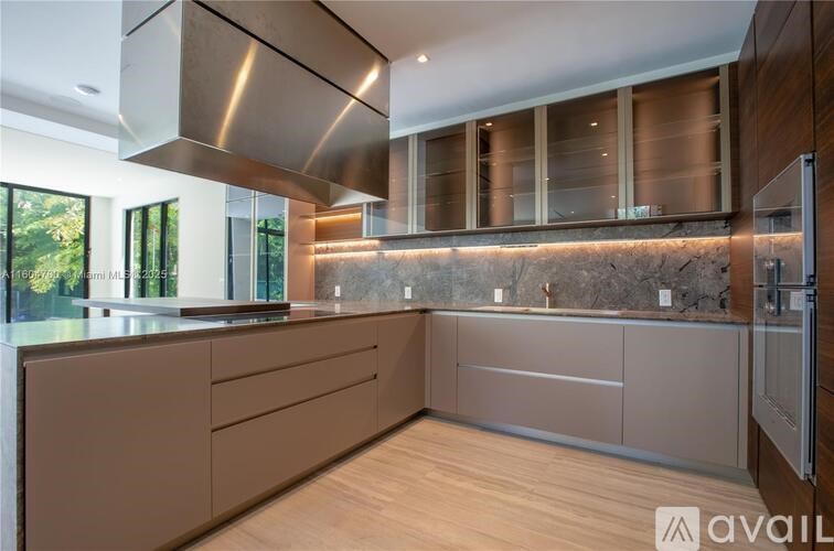 A modern kitchen with wooden cabinets and a stainless steel range hood.