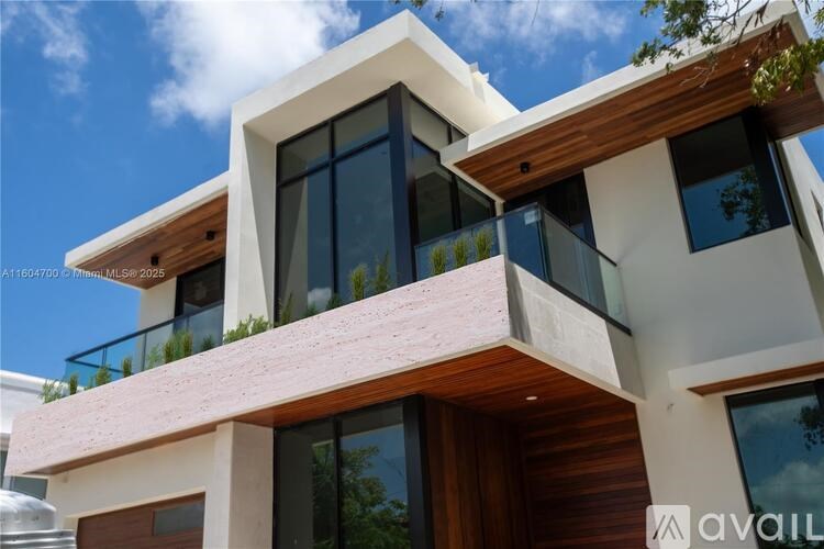 A modern house with a balcony and a brown roof.