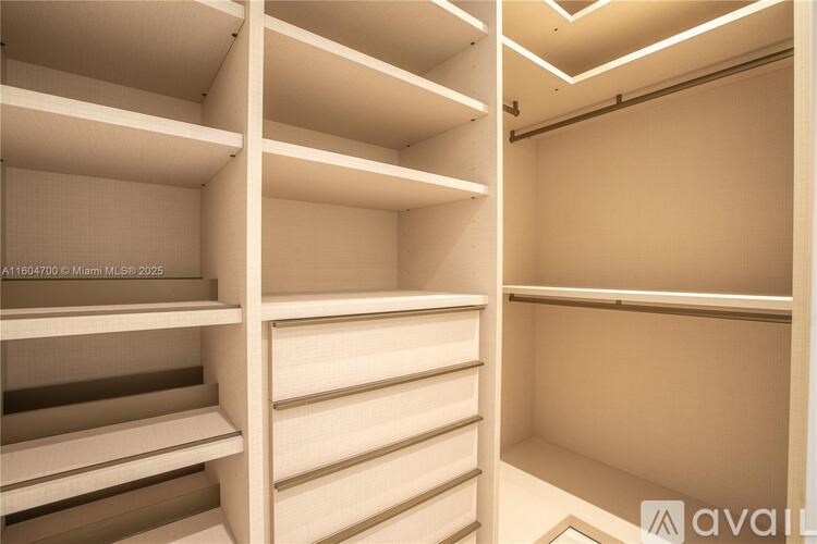 Empty white shelves in a room.