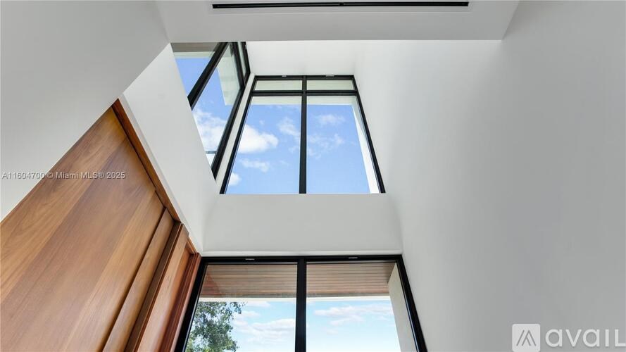 A modern interior with a skylight and a wooden structure.