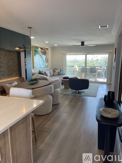 A living room with a white couch and a grey armchair.