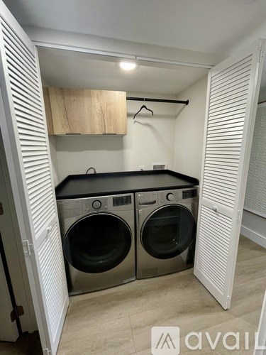 A small laundry room with a washer and dryer.