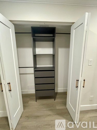 A white closet with a shelf and drawers.