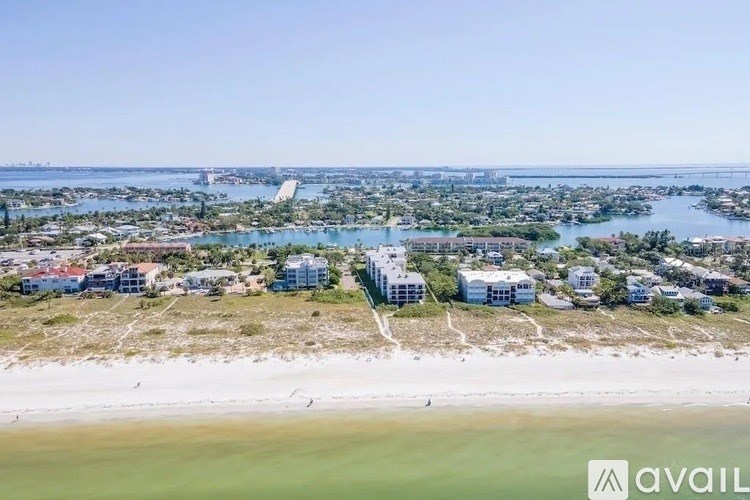 A beachfront community with a clear sky and calm waters.