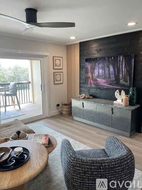 A living room with a grey sofa and a wooden coffee table.