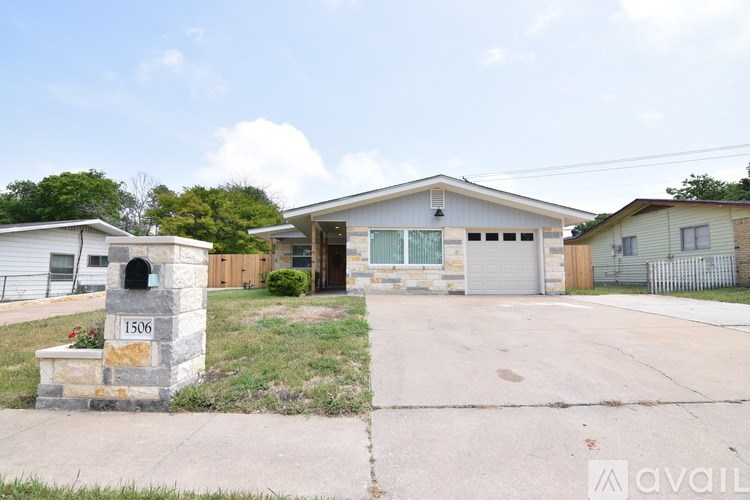 A house with the number 1506 on a stone pillar in front of it.
