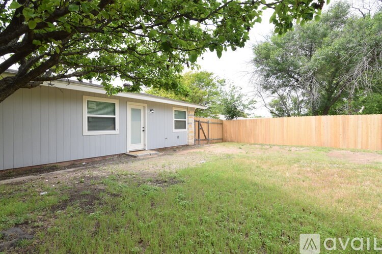 A house with a grey exterior and a brown fence.