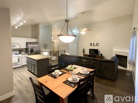 A modern dining room with a wooden table set for two.