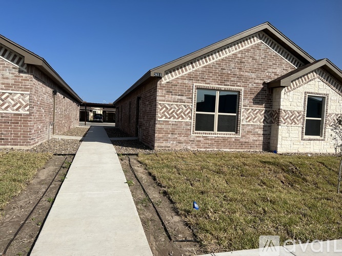 A brick building with a clear blue sky in the background.